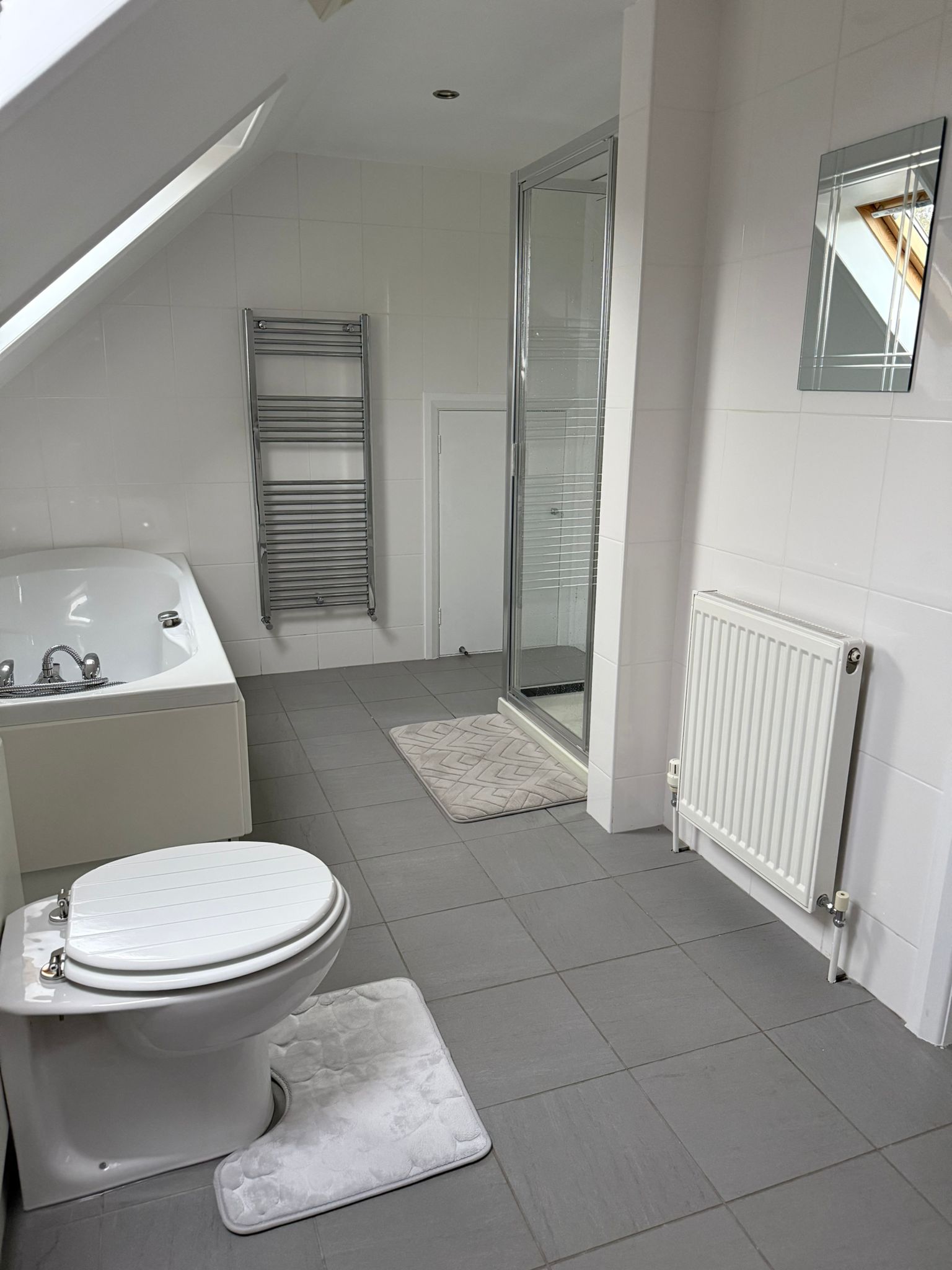 Bathroom angle showing shower and floor space.