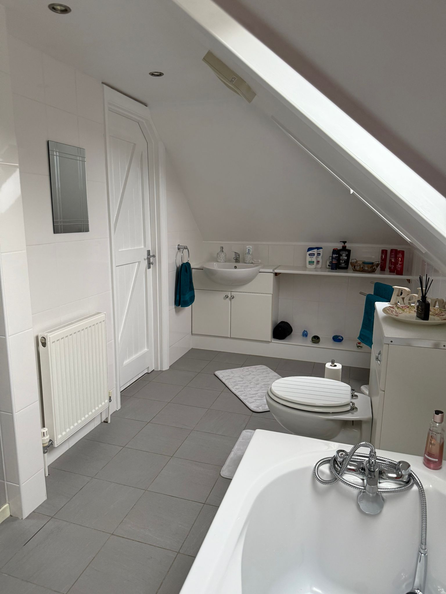 Bathroom view from the shower side with bathtub in focus.