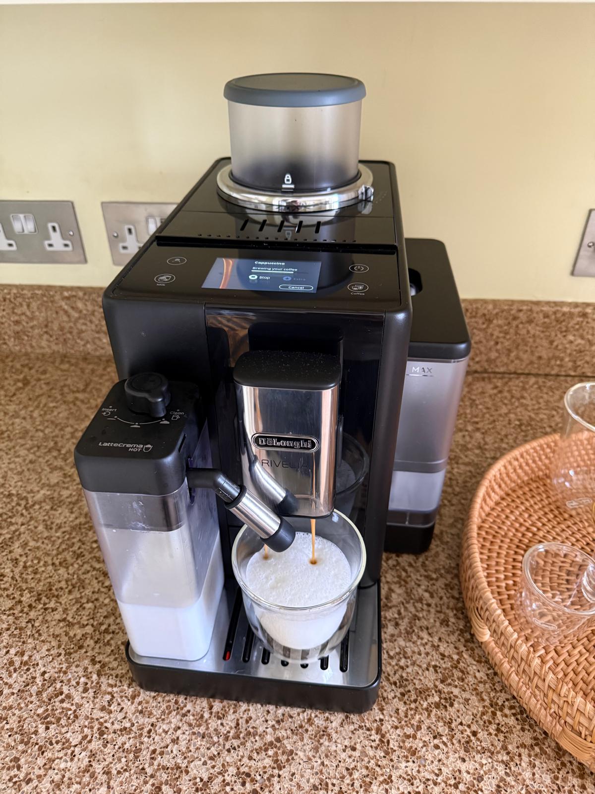 Coffee machine preparing a fresh milk coffee.