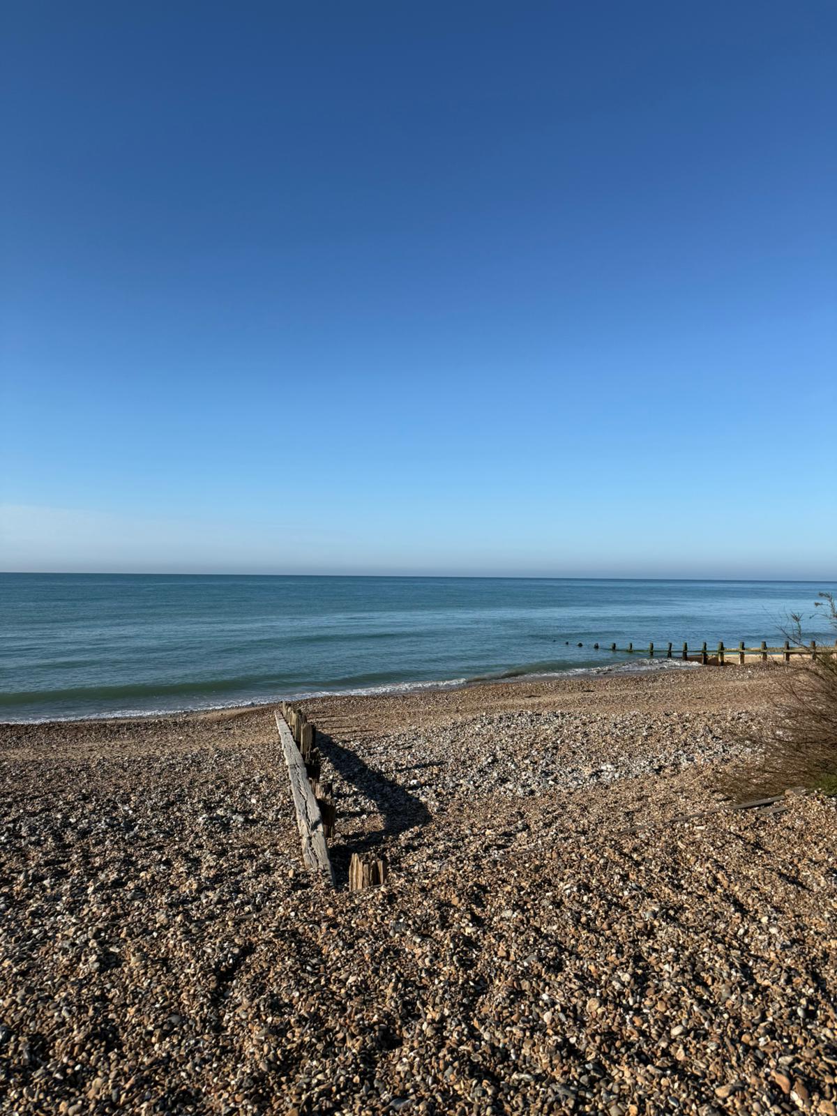 Open sea and shoreline on a bright day.